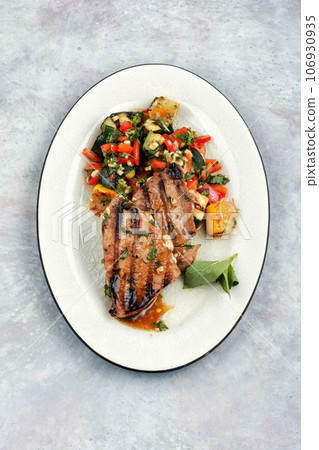 Tuna steak fried with grilled vegetables. Tuna steak fried with grilled vegetables. 106930935
