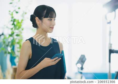 A woman watching a smartphone A woman watching a smartphone 106931366