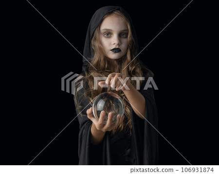 Halloween witch girl with crystal ball 106931874