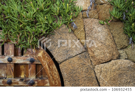 Fragment of a natural stone wall as a background or texture. The structure of the stone wall. Old castle stone wall texture background. Fragment of a natural stone wall as a background or texture. The structure of the stone wall. Old castle stone wall texture background. 106932455