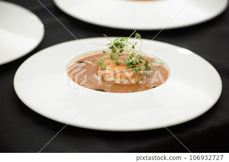 Tomato gazpacho soup served with burrata cheese. Tasty appetizing summer tomato soup Tomato gazpacho soup served with burrata cheese. Tasty appetizing summer tomato soup 106932727