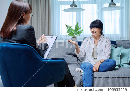 Mature woman at therapy meeting with psychologist 106933929