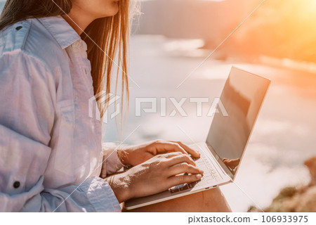 Woman sea laptop. Business woman in yellow hat freelancer with laptop working over blue sea beach. Girl relieves stress from work. Freelance, digital nomad, travel and holidays concept Woman sea laptop. Business woman in yellow hat freelancer with laptop working over blue sea beach. Girl relieves stress from work. Freelance, digital nomad, travel and holidays concept 106933975