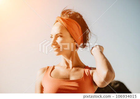 Woman sea yoga. Selective focus. Young beautiful caucasian woman in a red suit practicing yoga on the beach at sunrise near the sea. Yoga. Healthy lifestyle. Meditation concept. 106934015
