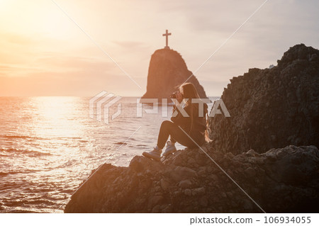 Woman travel sea. Happy tourist enjoy taking picture outdoors for memories. Woman traveler looks at sea bay of mountains, sharing travel adventure journey Woman travel sea. Happy tourist enjoy taking picture outdoors for memories. Woman traveler looks at sea bay of mountains, sharing travel adventure journey 106934055