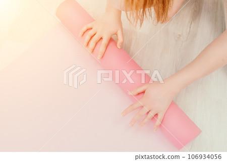 Young sporty woman, fitness instructor in sportswear doing stretching and pilates on yoga mat in the studio with mirror. Female fitness yoga routine concept. Healthy lifestyle and harmony. Young sporty woman, fitness instructor in sportswear doing stretching and pilates on yoga mat in the studio with mirror. Female fitness yoga routine concept. Healthy lifestyle and harmony. 106934056