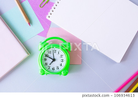 Back to school, alarm clock, colorful sticky notes and colorful pencils, drawing supplies on gray background with copy space, top view, flatly Back to school, alarm clock, colorful sticky notes and colorful pencils, drawing supplies on gray background with copy space, top view, flatly 106934613