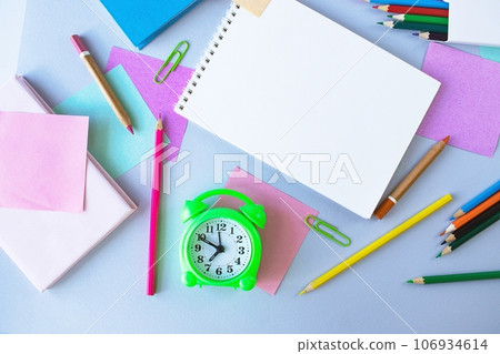 Back to school, alarm clock, colorful sticky notes and colorful pencils, drawing supplies on gray background with copy space, top view, flatly Back to school, alarm clock, colorful sticky notes and colorful pencils, drawing supplies on gray background with copy space, top view, flatly 106934614