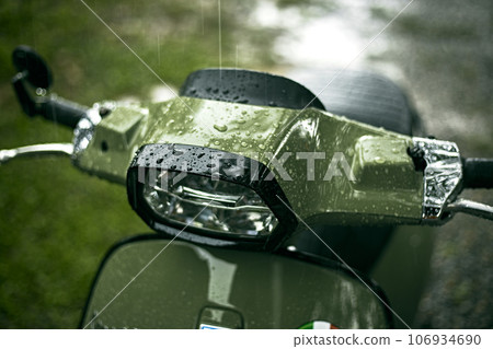 Close up green motorcycle scooter with raindrops Close up green motorcycle scooter with raindrops 106934690