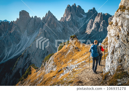 Famous hiking trail with hikers in the Dolomites, Italy 106935278