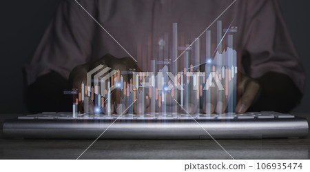 Stock market graph with man working on computer stock trading screen. 106935474