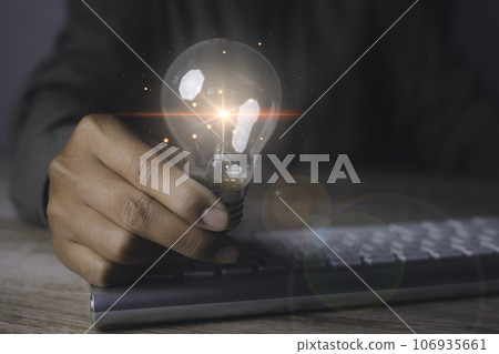 Creative idea and innovation. Businessman holding light bulbs the idea. 106935661
