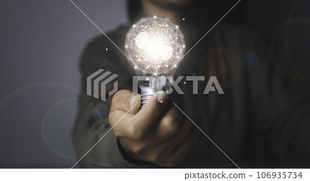 Creative idea and innovation. Businessman holding light bulbs the idea. Creative idea and innovation. Businessman holding light bulbs the idea. 106935734