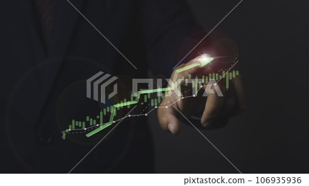 Stock market graph with man working on computer stock trading screen. 106935936