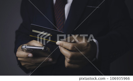 Businessman using mobile phone and credit card shopping online. Businessman using mobile phone and credit card shopping online. 106935966