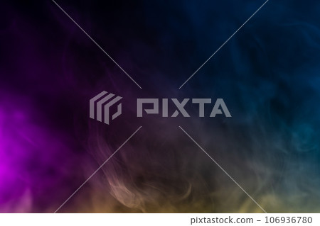 Blurred photo texture of colored smoke on a black background. 106936780