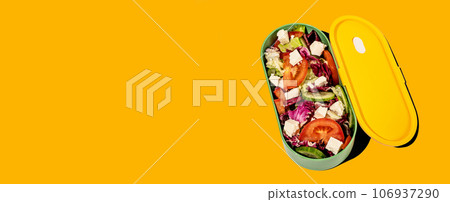 Vegetable salad in lunch box, yellow banner background Vegetable salad in lunch box, yellow banner background 106937290