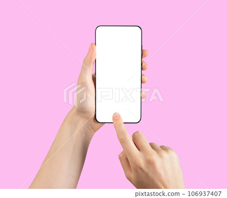 Hand holding mobile phone mockup, finger clicking on screen mock-up on pink background Hand holding mobile phone mockup, finger clicking on screen mock-up on pink background 106937407