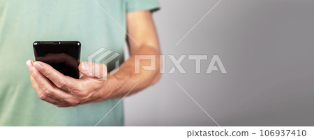 Hand holding mobile phone, smartphone, banner background Hand holding mobile phone, smartphone, banner background 106937410