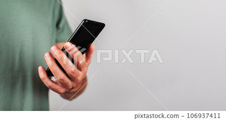 Hand holding mobile phone, using smartphone, cellphone, banner Hand holding mobile phone, using smartphone, cellphone, banner 106937411