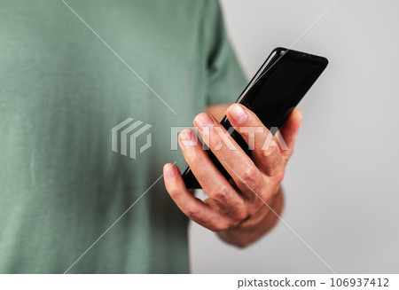 Hand holding mobile phone, using smartphone Hand holding mobile phone, using smartphone 106937412
