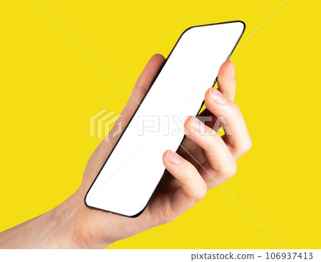 Hand holding smart phone mockup, mobile screen mock up on yellow background Hand holding smart phone mockup, mobile screen mock up on yellow background 106937413