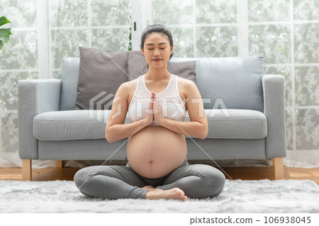 Happy Calm Pregnant Woman deep breath with fresh air do yoga lotus pose comfortable at home,Pregnancy of young woman relax with yoga to meditation for healthy life,Yoga Motherhood and Pregnant Concept Happy Calm Pregnant Woman deep breath with fresh air do yoga lotus pose comfortable at home,Pregnancy of young woman relax with yoga to meditation for healthy life,Yoga Motherhood and Pregnant Concept 106938045