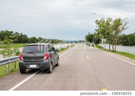 Behind a small car parked on a provincial road. Behind a small car parked on a provincial road. 106938055