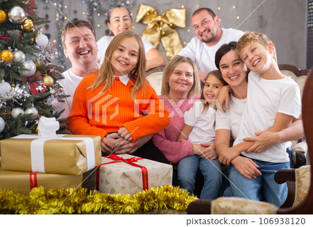 Family with children on sofa in christmas interior Family with children on sofa in christmas interior 106938120