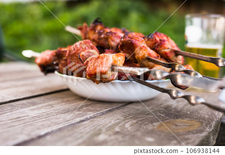 Top view of tasty shish kebab from pork on plate 106938144
