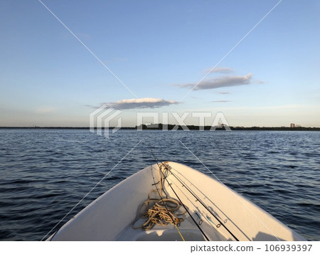 seascape with a fishing boat with fishing rods 106939397