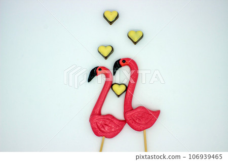 Two flamingo-shaped lollipop candies Two flamingo-shaped lollipop candies 106939465