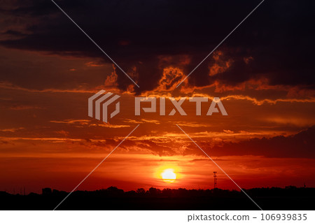 Beautiful Dark Orange sunrise behind clouds over Nebraska 106939835