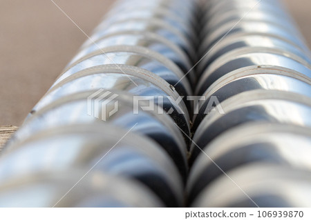 View Close-up injection machine screw spare parts injection machine manufacturing process concept. 106939870