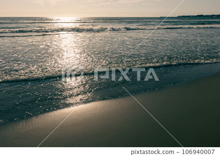 Calm sandy beach at sunset 106940007