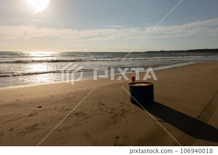 Calm sandy beach at sunset 106940018