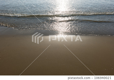 Calm sandy beach at sunset 106940021