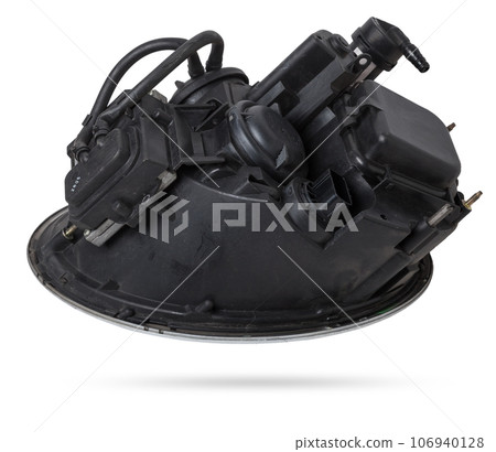 Stylish xenon headlight of a German car - optical equipment with a lamp inside on a white isolated background. Spare part for auto repair in a car workshop. Stylish xenon headlight of a German car - optical equipment with a lamp inside on a white isolated background. Spare part for auto repair in a car workshop. 106940128