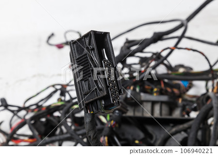 A modern car connector or trailer for closing an electrical circuit that a mechanic holds in gloves during repairs. A modern car connector or trailer for closing an electrical circuit that a mechanic holds in gloves during repairs. 106940221