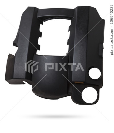 Black plastic engine cover on a white background in a photo studio as a separate spare part for sale at an auto-parsing or for replacement when repairing a car in the service. Black plastic engine cover on a white background in a photo studio as a separate spare part for sale at an auto-parsing or for replacement when repairing a car in the service. 106940222