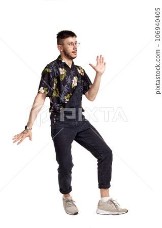 Full-length portrait of a funny guy dancing in studio isolated on white background. 106940405