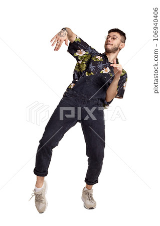Full-length portrait of a funny guy dancing in studio isolated on white background. 106940406