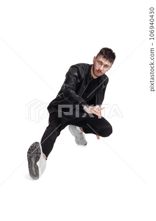 Full-length photo of a funny guy dancing in studio isolated on white background. 106940430
