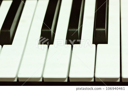 Black white keys piano, synthesizer up close in recording studio.Professional Hi-Fi sound equipment for music producer. Keyboard for making music. A musical instrument photography. Electronic music. Black white keys piano, synthesizer up close in recording studio.Professional Hi-Fi sound equipment for music producer. Keyboard for making music. A musical instrument photography. Electronic music. 106940461