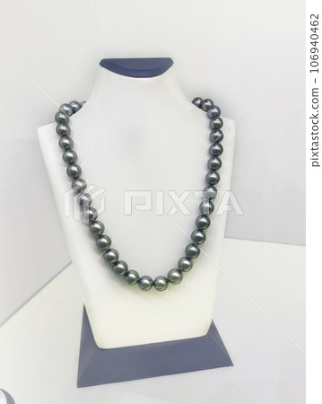 beautiful gray natural sea pearls necklaces demonstrated on model. fashion and jewelry concept beautiful gray natural sea pearls necklaces demonstrated on model. fashion and jewelry concept 106940462