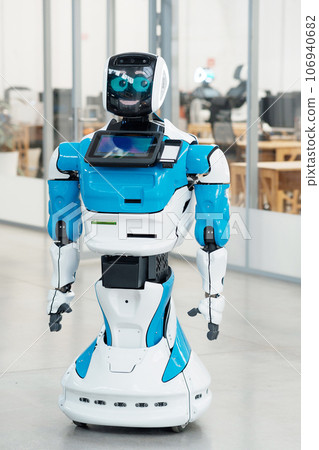 humanoid robot with a friendly face in the interior of a modern office humanoid robot with a friendly face in the interior of a modern office 106940682