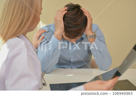 Doctor comforting patient in hospital. The patient is worried about his illness. Doctor comforting patient in hospital. The patient is worried about his illness. 106940865