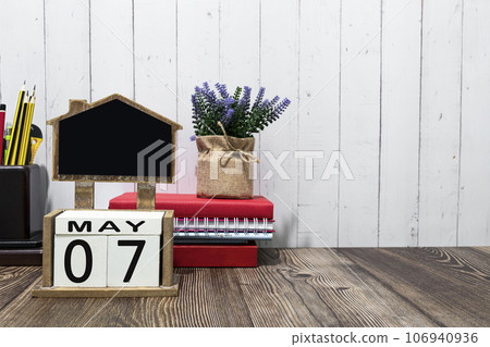 calendar date text on white wooden block with stationeries on wooden desk calendar date text on white wooden block with stationeries on wooden desk 106940936