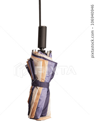 Closed folded umbrella hanging on string rope, isolated on white 106940946