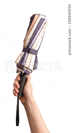 Hand holding closed folded umbrella, isolated on white background 106940956